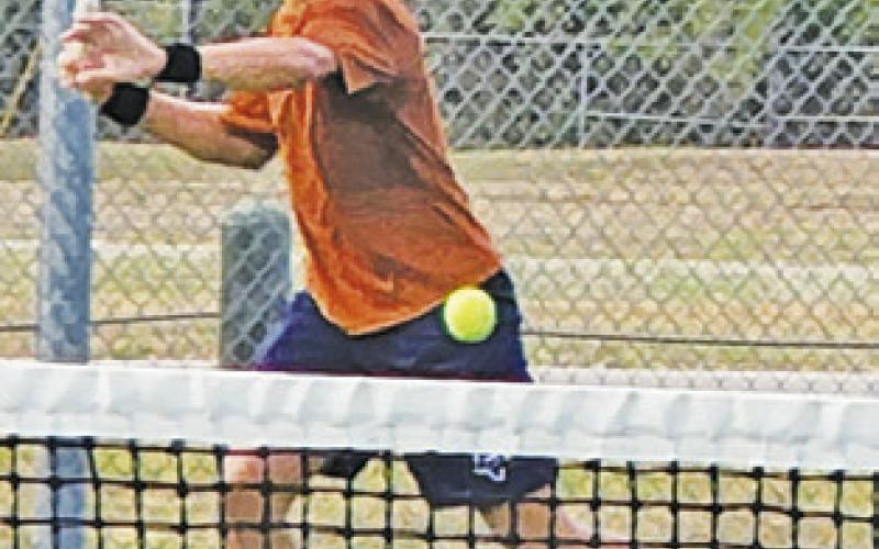 CALDWELL’S WAYLON Chapman sets to hit the ball during a tennis match in Bastrop.