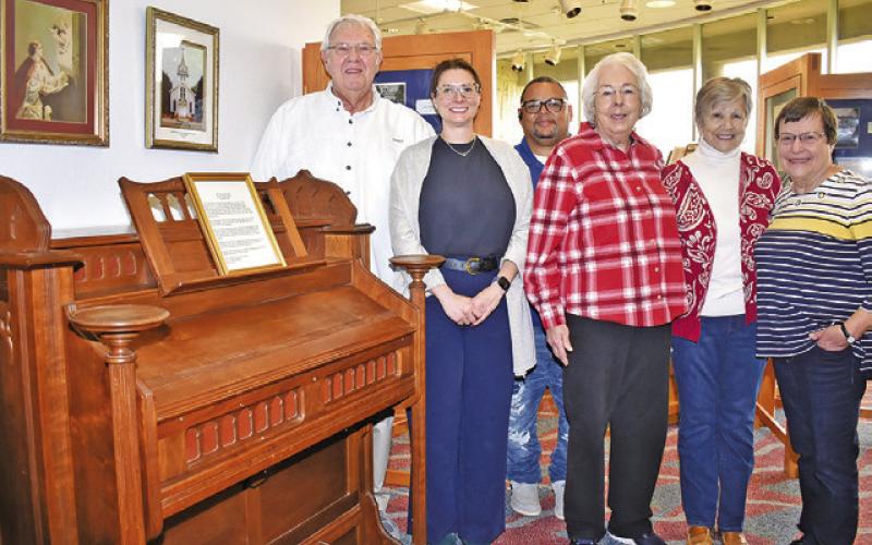 JOE RYCHLIK AND Caldwell Museum board members stand next to the organ. They include Kate Borroni, Donna Rychlik, LouAnn Englemann and Linda Chamberlain. Joining them was Chad Rogers, civic/visitors center coordinator. -- Tribune photo by Roy Sanders