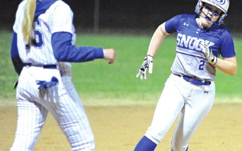 SNOOK’S AUBREY BECKER rounds third on her way to score during the Snook-Anderson-Shiro game last Friday night in Snook.