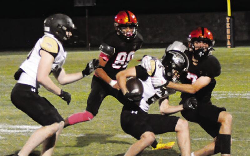 SOMERVILLE’S KASON ROHRBACH and Victor Orozco move in for a tackle against Buda Johnson. -- Tribune photo by Denise Squier