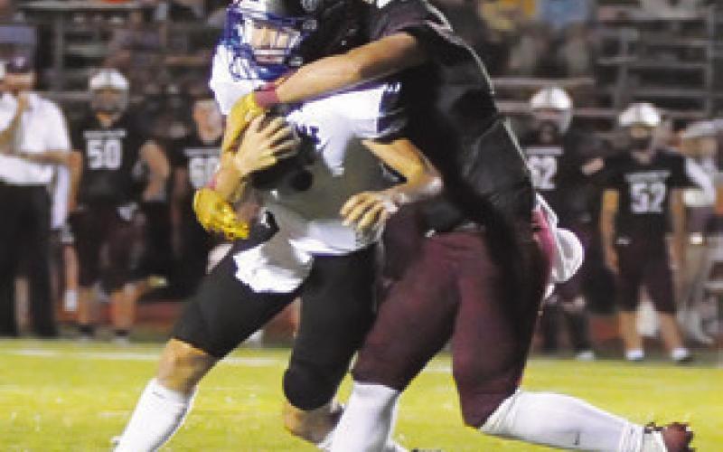 SNOOK QUARTERBACK BRETT Withem is tackled by a Tarkington defender. Tribune photo by Denise Squier