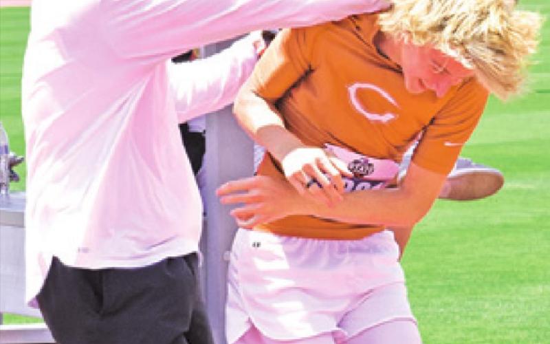 COACH TRAVIS McFARLAND congratulates Daniel Cowan after another successful jump.