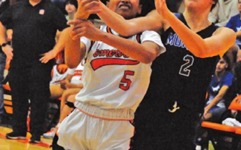 DESTINY VELA IS fouled while trying to drive down the lane to shoot the ball during the Somerville-Mumford game last week.