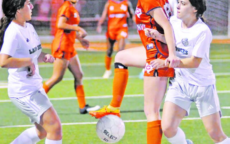 CALDWELL SENIOR AND TEAM captain Cadie Coston is challenged by two Taylor players during the Lady Hornets’ final district game this season at Hornet Field. -- Tribune photo by Denise Squier