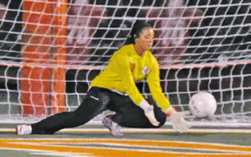 GOALKEEPER MERCY Chollett grabs the ball, preventing a Taylor score.