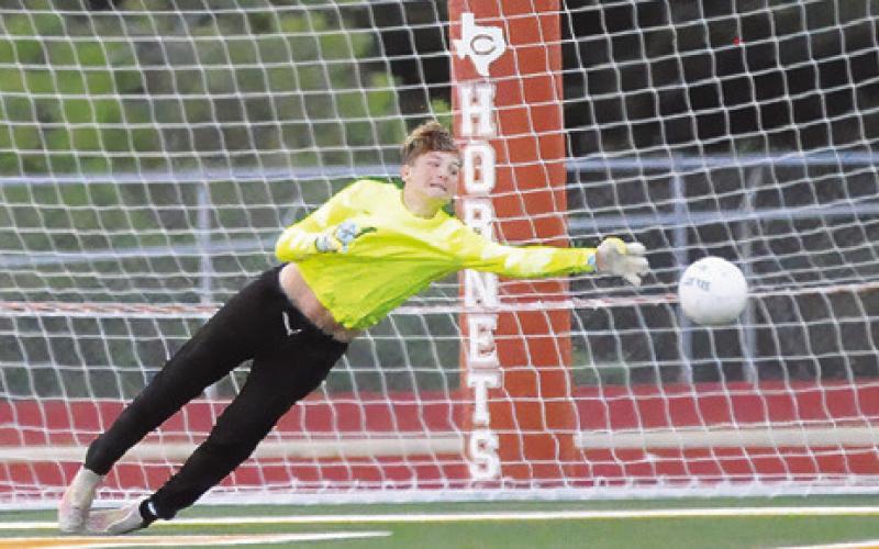 CALDWELL GOALKEEPER TYLER Boyd grabs the ball to save a goal during the Hornets’ final game of the season against Taylor. -- Tribune photo by Denise Squier.