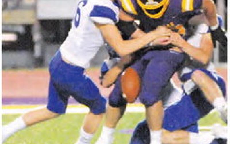 SILAS HETLAND and Snook teammates force a fumble last Friday against Weimar.