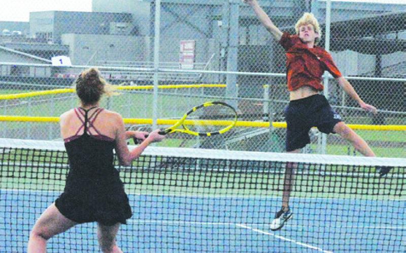 CALDWELL’S BREYDEN ATHEY volleys the ball during a mixed doubles match with partner Hope Savage last week. -- Tribune photo by Denise Squier