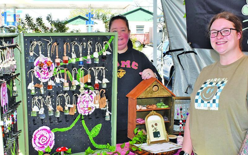 BRIANNA KELLER AND Rachael Schwab of Nanners Freshies &amp;amp; Such work their booth on Sunday at the Somerville Farmers Market.