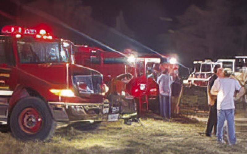 AREA FIREFIGHTERS RESPOND ON Monday at the grass fire off County Road 324 near the F.M. 696 intersection.