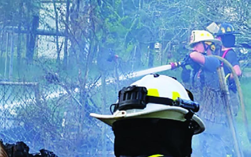 FIREFIGHTERS FROM SNOOK and Cooks Point battle this house fire on Sunday afternoon off County Road 249. Photo courtesy of Snook Volunteer Fire Department