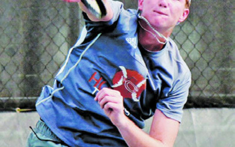 RYAN SEE SERVES to an Academy player during the Caldwell-Academy team tennis match last Monday in Caldwell.