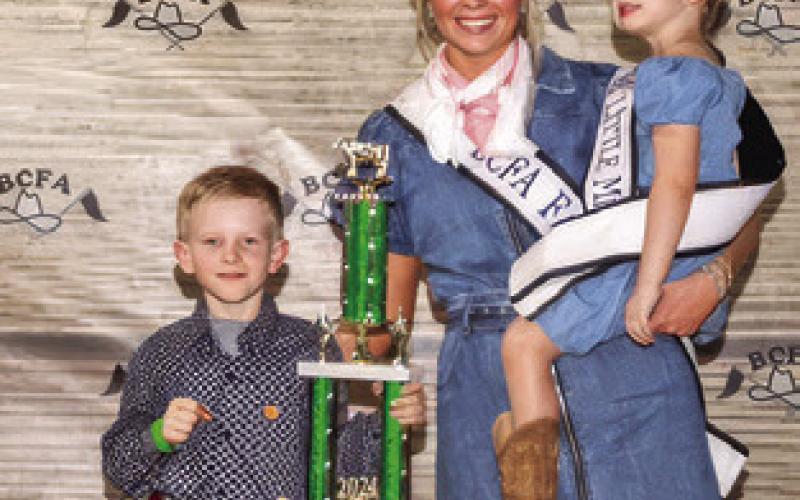 JOSEPH CHARANZA exhibited the Grand Champion Commercial Heifers at this year’s Burleson County Fair. He is pictured with Burleson County Fair Queen Hadleigh Novosad and Little Miss Avery Freeman.