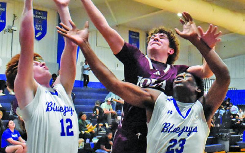 BRETT TURNER AND Ke’Treen Carter fight for this rebound. Tribune photo by Roy Sanders