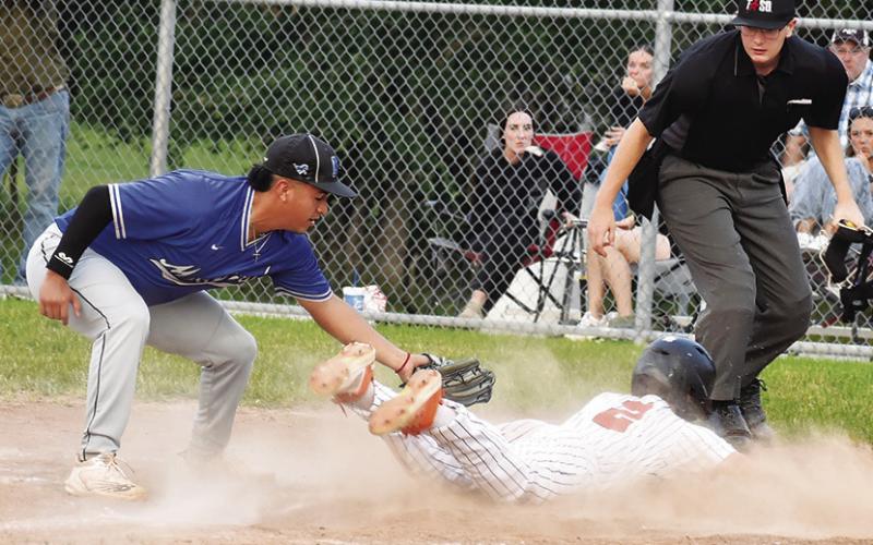 SOMERVILLE’S COLT HOLTON slides into home for a run for Somerville in the Mumford game. -- Tribune photo by Roy Sanders