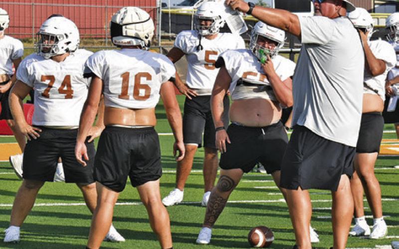 CALDWELL HEAD COACH Sean Witherwax talks to his players during a Monday, Aug. 24, workout at Hornet Stadium. Tribune photo by Roy Sanders