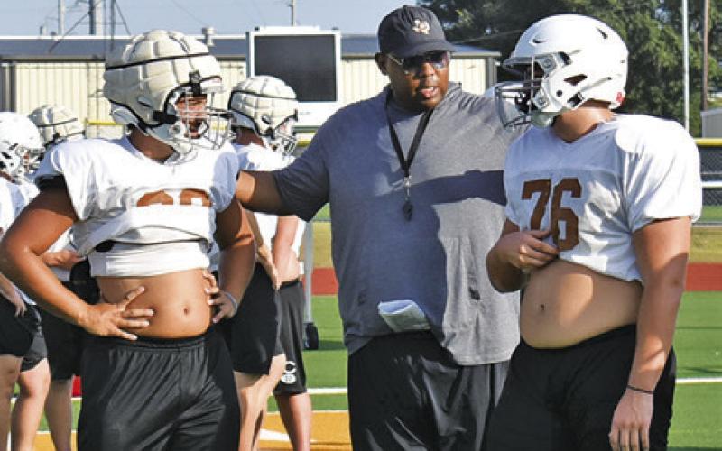 CALDWELL ASSISTANT COACH John Branch talks to the players during the Monday, Aug. 24, workout at Hornet Stadium. Tribune photo by Roy Sanders