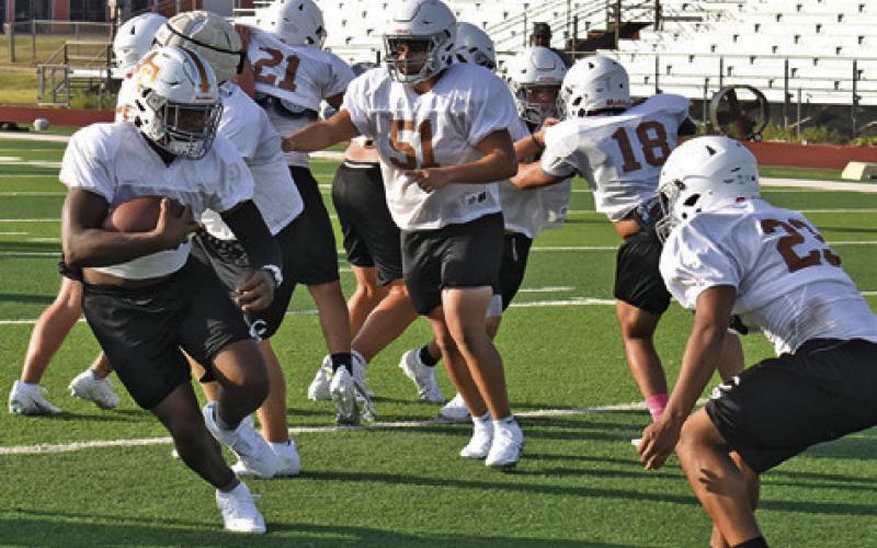 CALDWELL RUNNING BACK Michael Butler carries the ball during practice on Monday, Aug. 24, at Hornet Stadium. Tribune photo by Roy Sanders