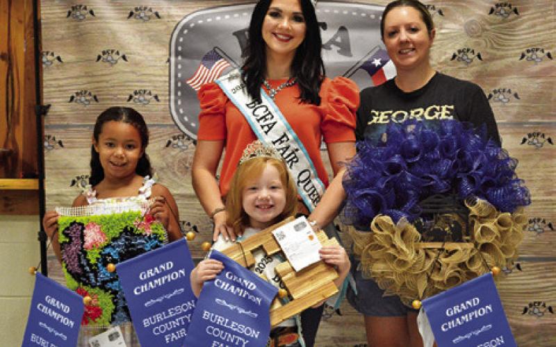 IVEY LEWIS WON GRANDS IN Children’s Corner Canned Foods, Creative Arts and Crafts and Needlework, and Hannah Kovar won grand in Adult Creative Arts and Crafts. Also pictured are Fair Queen Kodi Hitchcock and Little Miss Taytum Hohlt. Tribune photo by Sabine Lazo