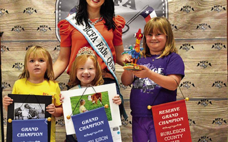 MADISON AND KINLEY GODWIN won grands in Children’s Corner Photography. Also pictured are Fair Queen Kodi Hitchcock and Little Miss Taytum Hohlt. Tribune photo by Sabine Lazo