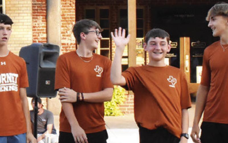 CALDWELL HIGH SCHOOL tennis team members greet the crowd on Saturday at the Meet the Hornets celebration.