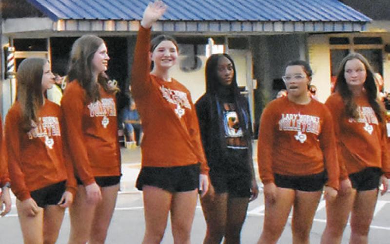 CALDWELL HIGH SCHOOL volleyball team members wave to the crowd on Saturday at the Meet the Hornets celebration.