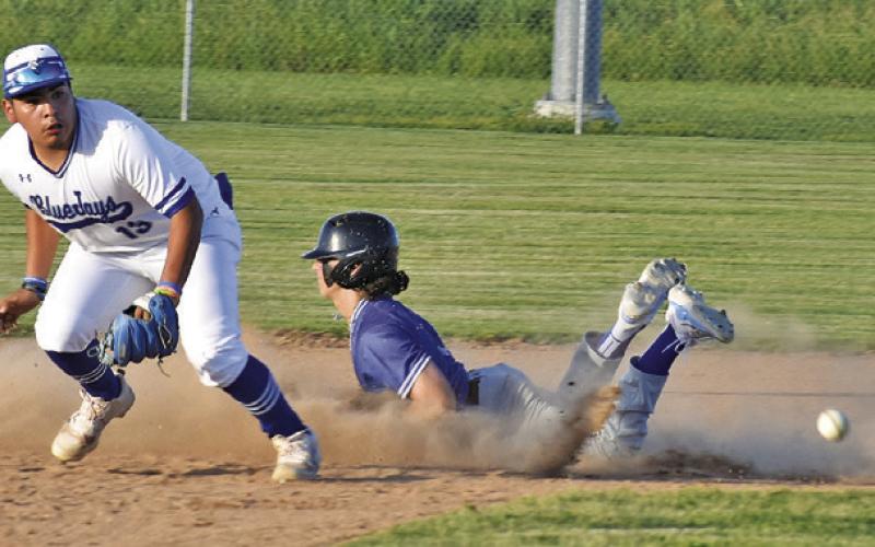 SNOOK’S JACOB CASTANEDA watches the ball as this Mumford base runner slides into second base in last Friday’s game. -- Tribune photo by Roy Sanders