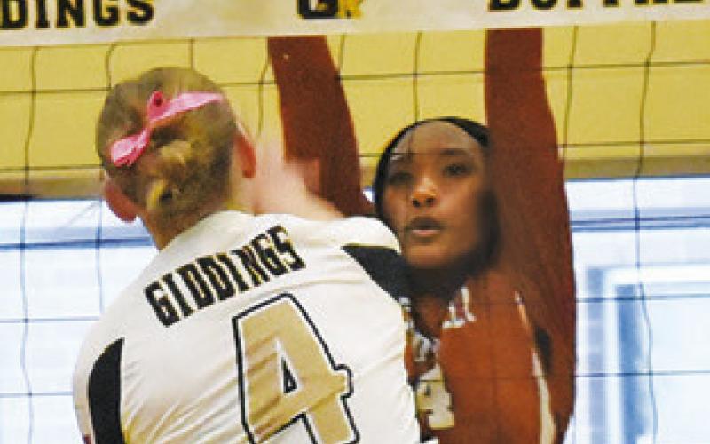 TYNIAH JOHNSON gets a block on Giddings’ Karleigh Blansit during the Caldwell-Giddings match last Friday in Giddings. Tribune photo by Roy Sanders