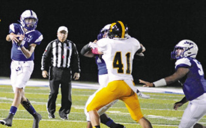 J. BEAUX HRUSKA hurls as pass against Yorktown last Friday at home. Snook lost 54-28. -- Tribune photo by Denise Squier