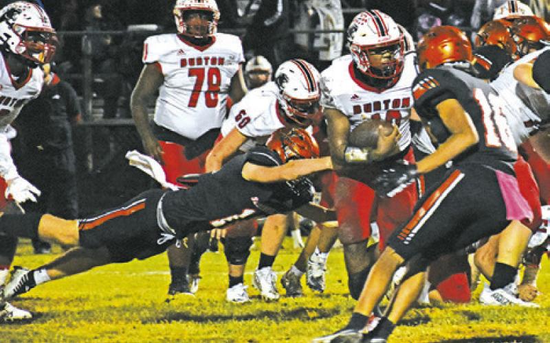 SOMERVILLE’S KUTTER ROHRBACH dives to make this tackle as Gardner Shivers moves in. -- Tribune photo by Roy Sanders