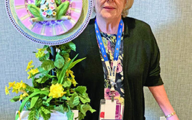 CLAUDIE PITMAN of Lyons EEA won second place at the state conference for yard art.