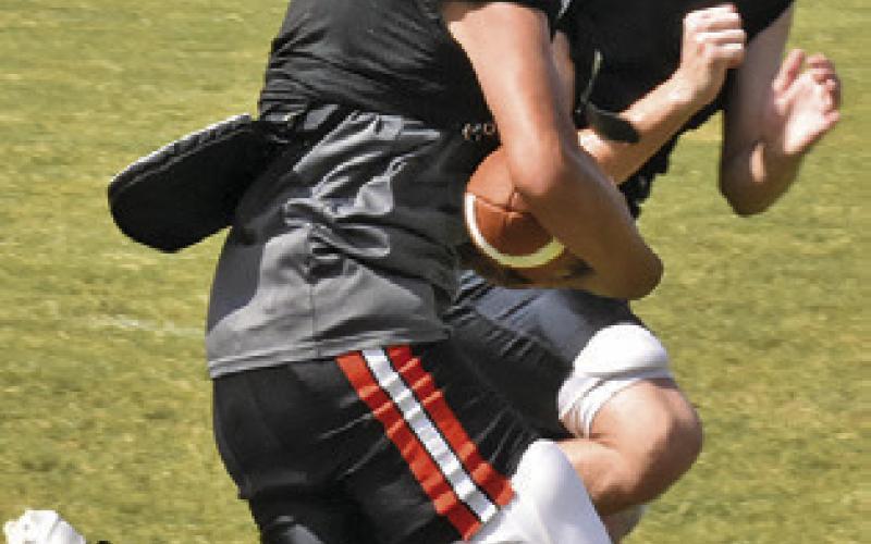 MANUEL LUCIO carries the ball during practice as Gage Tuck moves in to make the tackle.