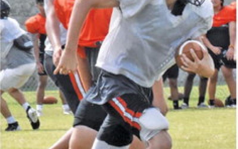 BRADLEY BRYANT carries the ball. Also pictured are Luke Moses and Omar Carrillo.