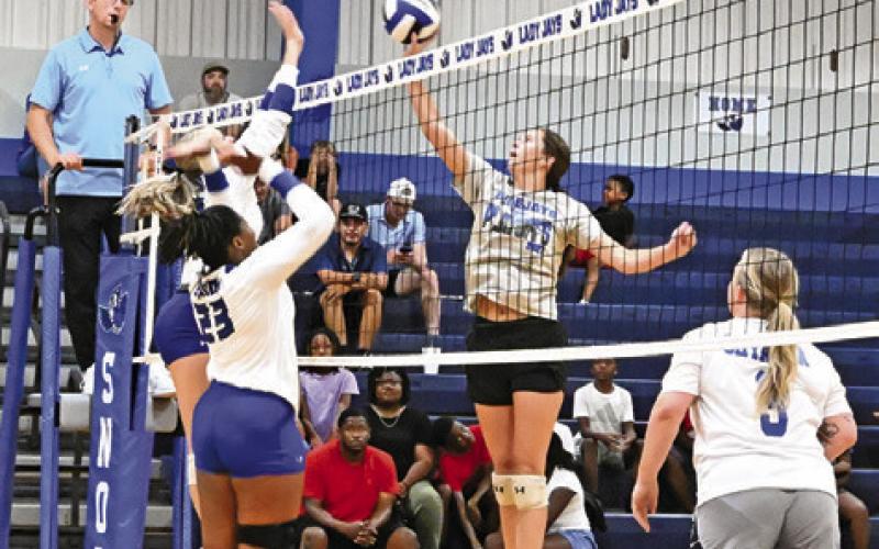 CURRENT LADY JAY PLAYERS, Dakota Kienow of Jai’Nylah Curry, attempt to block a hit from alumni player Riley Green. Tribune photo by Denise Squier