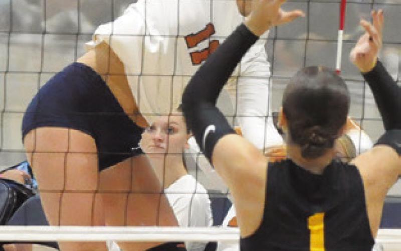 REESE MCMANUS gets a kill against Klein Oak during Caldwell’s match against Klein Oak at last week’s Legends Invitational. Tribune photo by Denise Squier