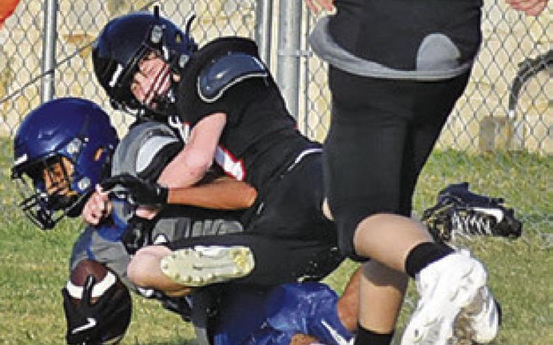 SOMERVILLE STOPS a Leon ball carrier in the Friday scrimmage in Somerville. Tribune photo by Roy Sanders