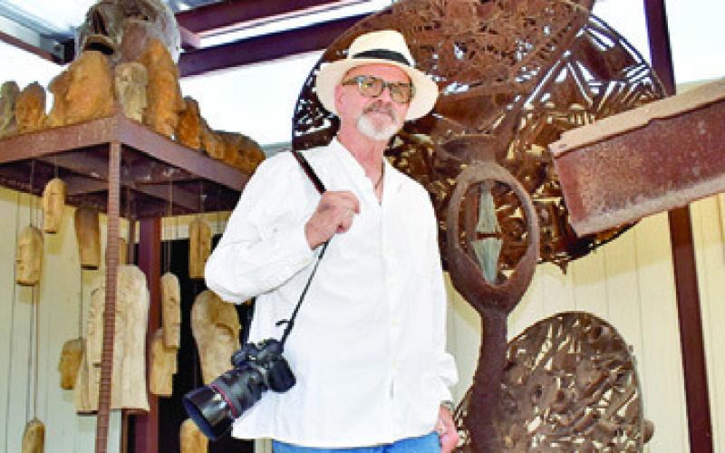 GRIFF SMITH STANDS next to his father Dr. Joe Smith’s sculptures at his home in Caldwell. Photography is his long-time passion. Tribune photo by Roy Sanders