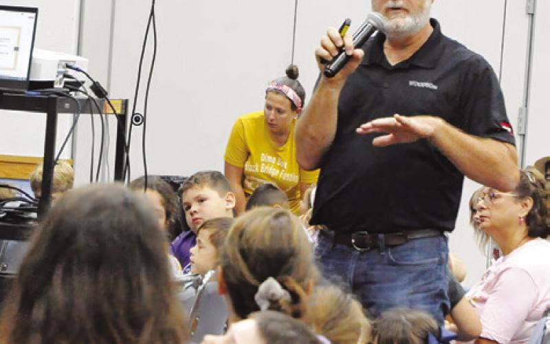 LOCAL BEEKEEPER, PATRICK Schilling, spoke to area children about the world of beekeeping, bees, wasps and more during last Thursday’s “The Un-bee-lievable life of bees” event hosted by the Harrie P. Woodson Memorial Library. Tribune photo by Denise Squier