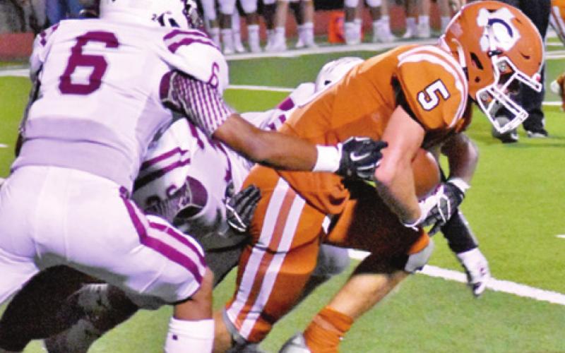CALDWELL’S JACE ALY fights for extra yards against Cameron.