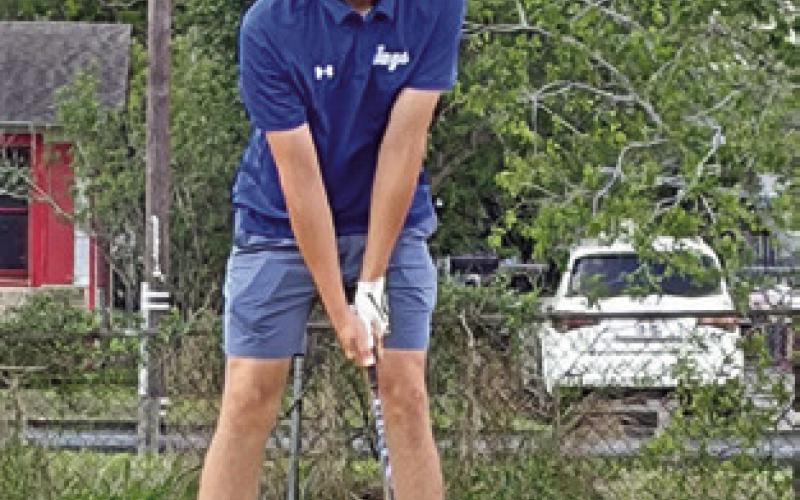 ALBERTO NORWOOD prepares to tee off for Snook at the regional golf tournament.