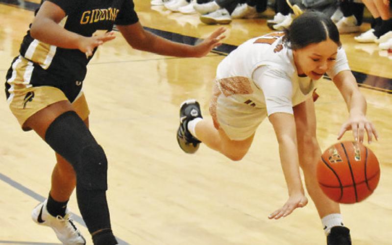 CALDWELL’S CHASSIDY ROGERS chases down the ball during the Lady Hornets’ 50-36 home loss to Giddings on Friday.