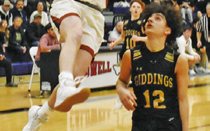 NATHAN SCOTT of Caldwell leaps high for this shot. -- Tribune photo by Roy Sanders