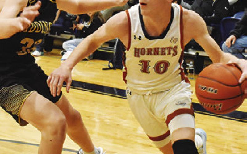 TRAVIS CUNNINGHAM of Caldwell dribbles the ball past this Giddings defender.