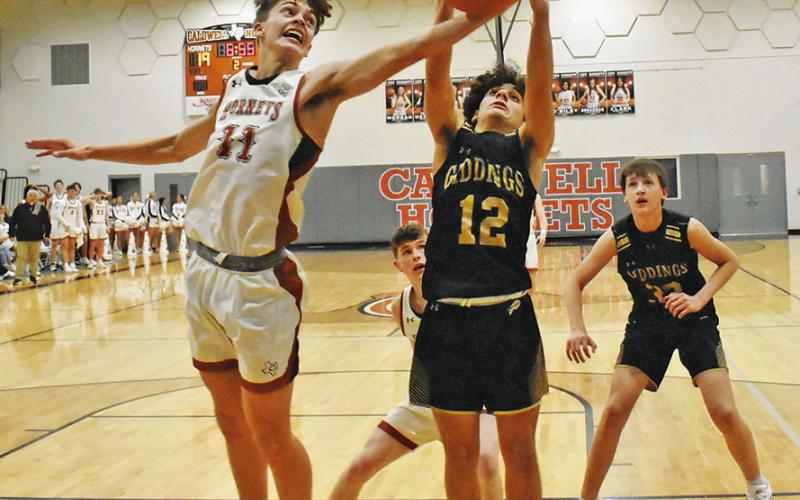GRANT McMANUS OF Caldwell reaches for this steal against Giddings. Caldwell won 55-34. Tribune photo by Roy Sanders