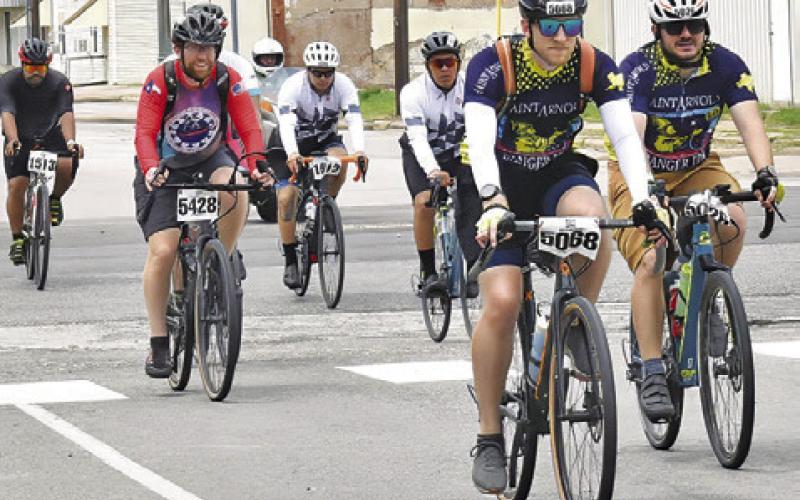 BIKERS FROM THE MS 150 bike ride make their way into Somerville on Sunday, April 28, headed for F.M. 1361 and on to College Station.