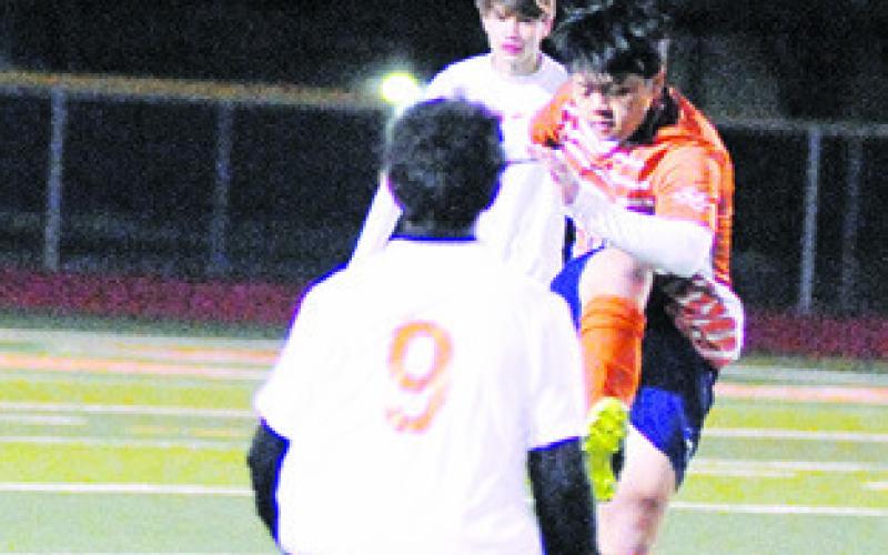 CALDWELL’S NAM Le kicks an aerial pass to a teammate during Caldwell’s win over Smithville last Friday. -- Tribune photo by Denise Squier