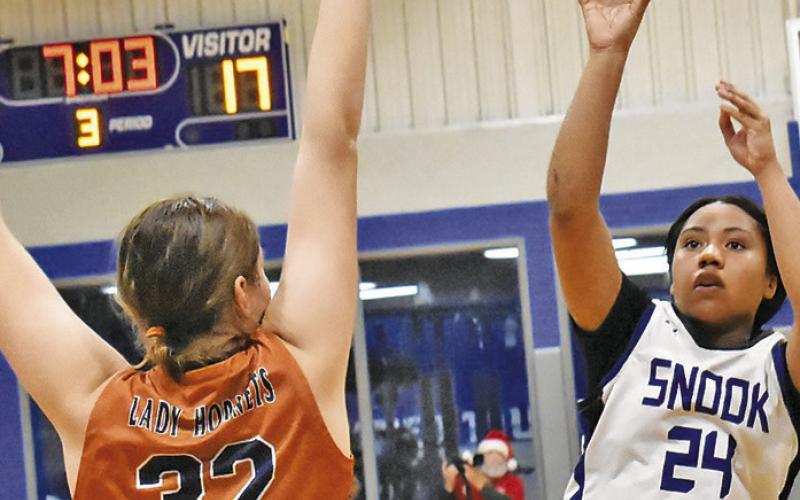 SNOOK’S ALANA STRINGFELLOW shoots over Caldwell’s Riley Broaddus in the Lady Jays’ 28-25 win over the Lady Hornets last Friday night in Snook. -- Tribune photo by Roy Sanders