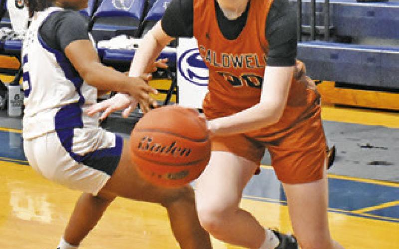 IRELAND MORGAN dribbles past Braynija Pool during Friday’s Snook-Caldwell game.