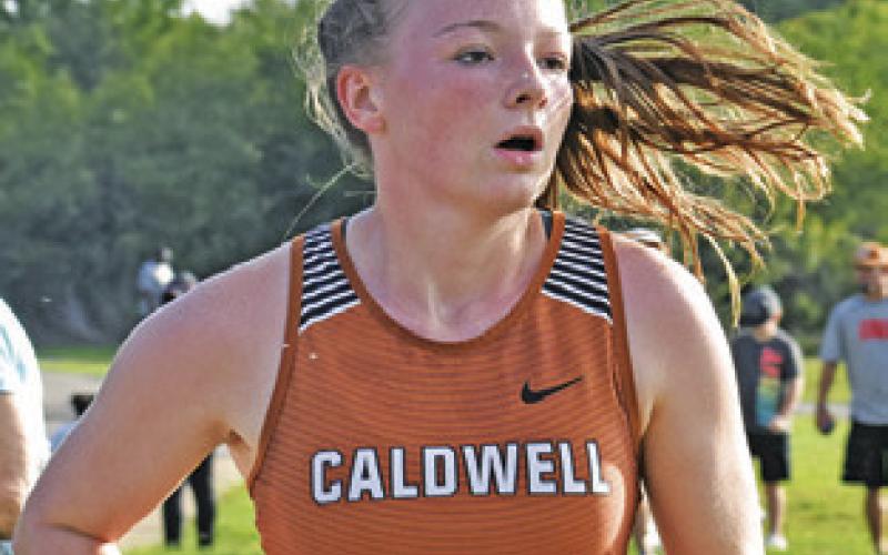 CALDWELL’S CADIE Coston runs during the varsity girls race of the Caldwell Invitational last Saturday at Davidson Creek Park.