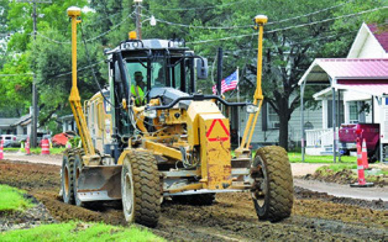 A CONSTRUCTION CREW from Texas Materials Group continues their road and drainage work on F.M. 975 on Monday, July 7, in this TxDOT project. Work is being done from State Highway 21 West to the UPR bridge rail with completion set for the spring of 2026, TxDOT said.